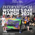Poster for International Women’s Day March 2026 organised by SA Unions Women’s Standing Committee. The image shows four people marching in a street rally, holding a colourful banner that reads “International Women’s Day – Why we march” with words like “Solidarity,” “Justice,” “Safety,” “Respect,” and “Equality.” Event details at the bottom state: Saturday 7 March, Tarntanyangga Victoria Square, 10:15am for a 10:30am start. A raised fist graphic appears in the bottom right corner.
